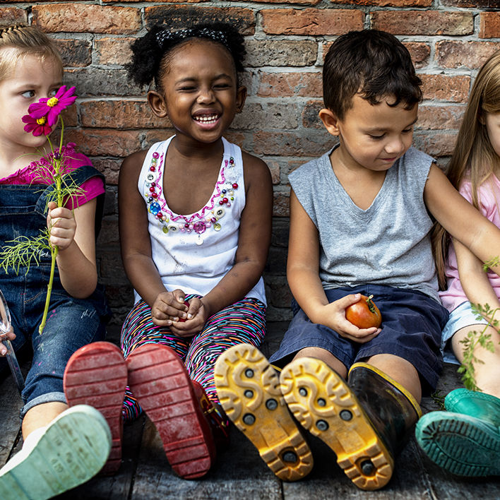 Group of kindergarten kids little farmers learning gardening